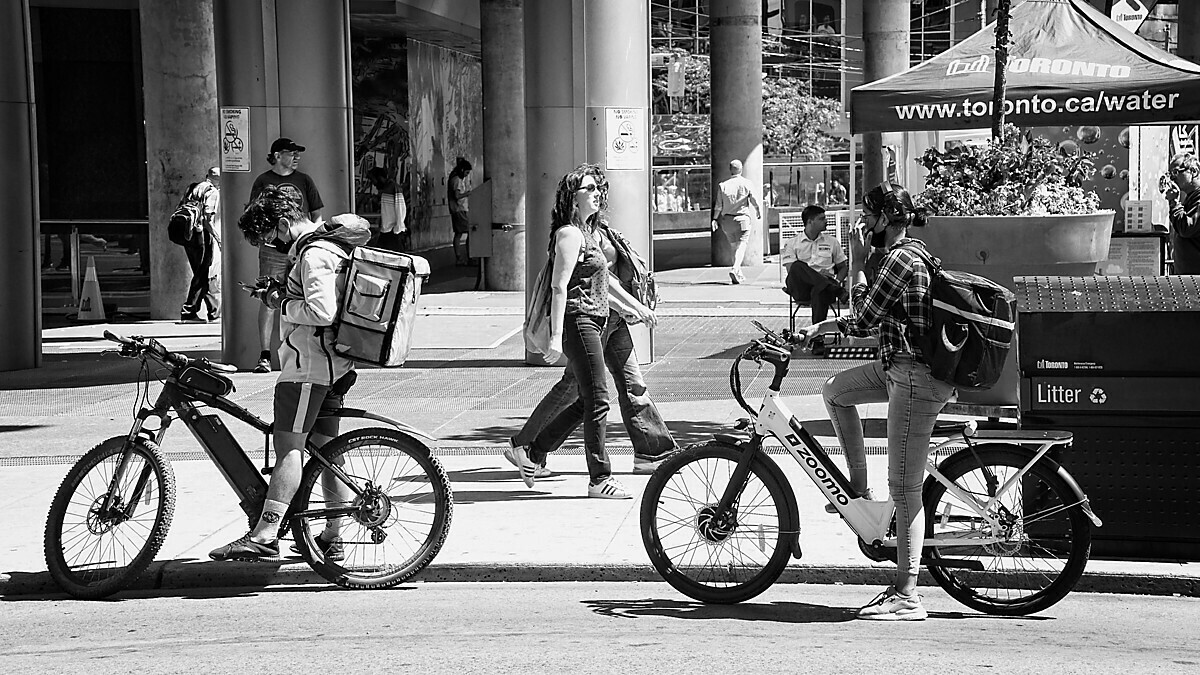 Cyclists waiting for traffic signal.